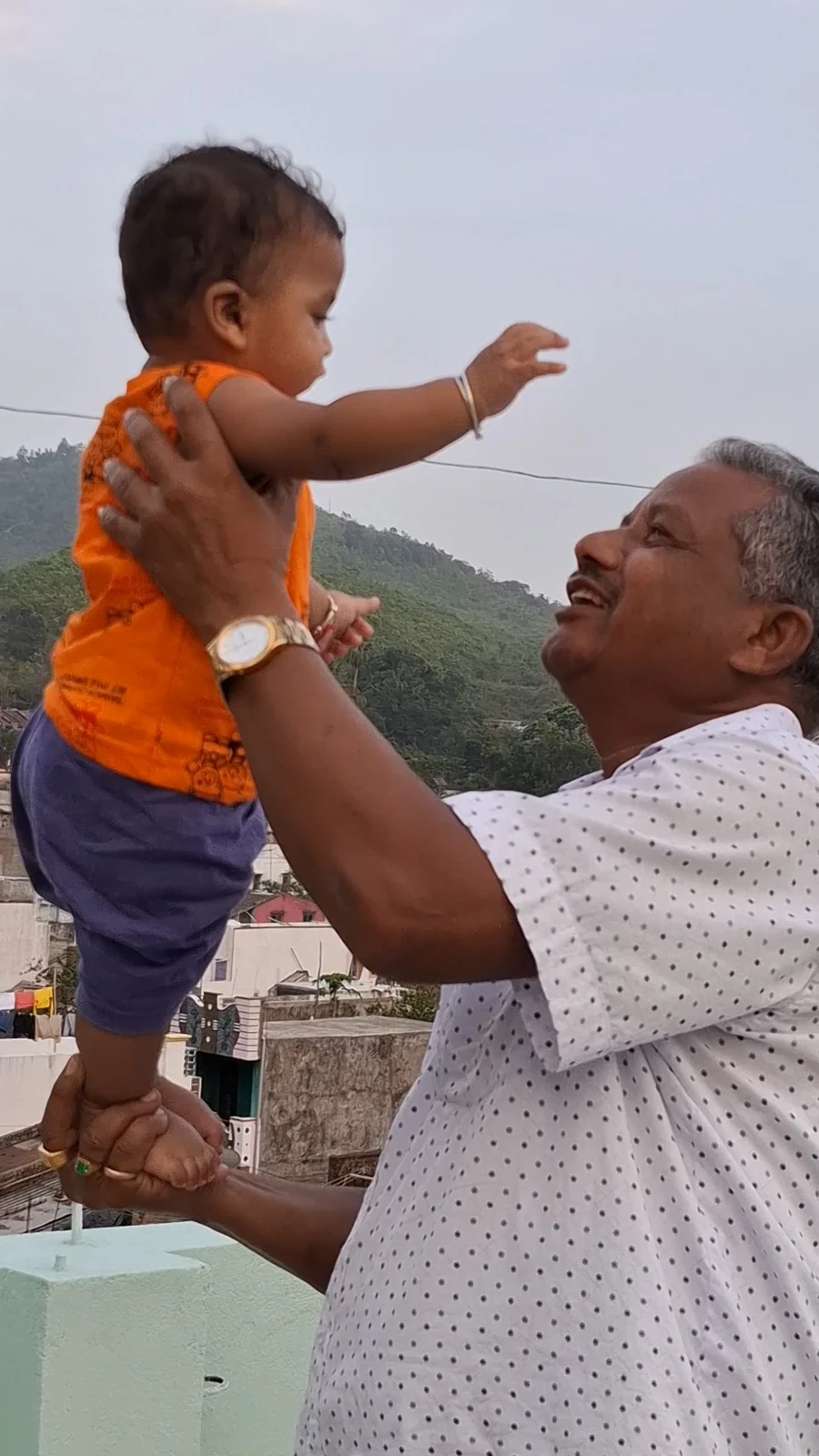 A family member lifting our little one into the evening sky